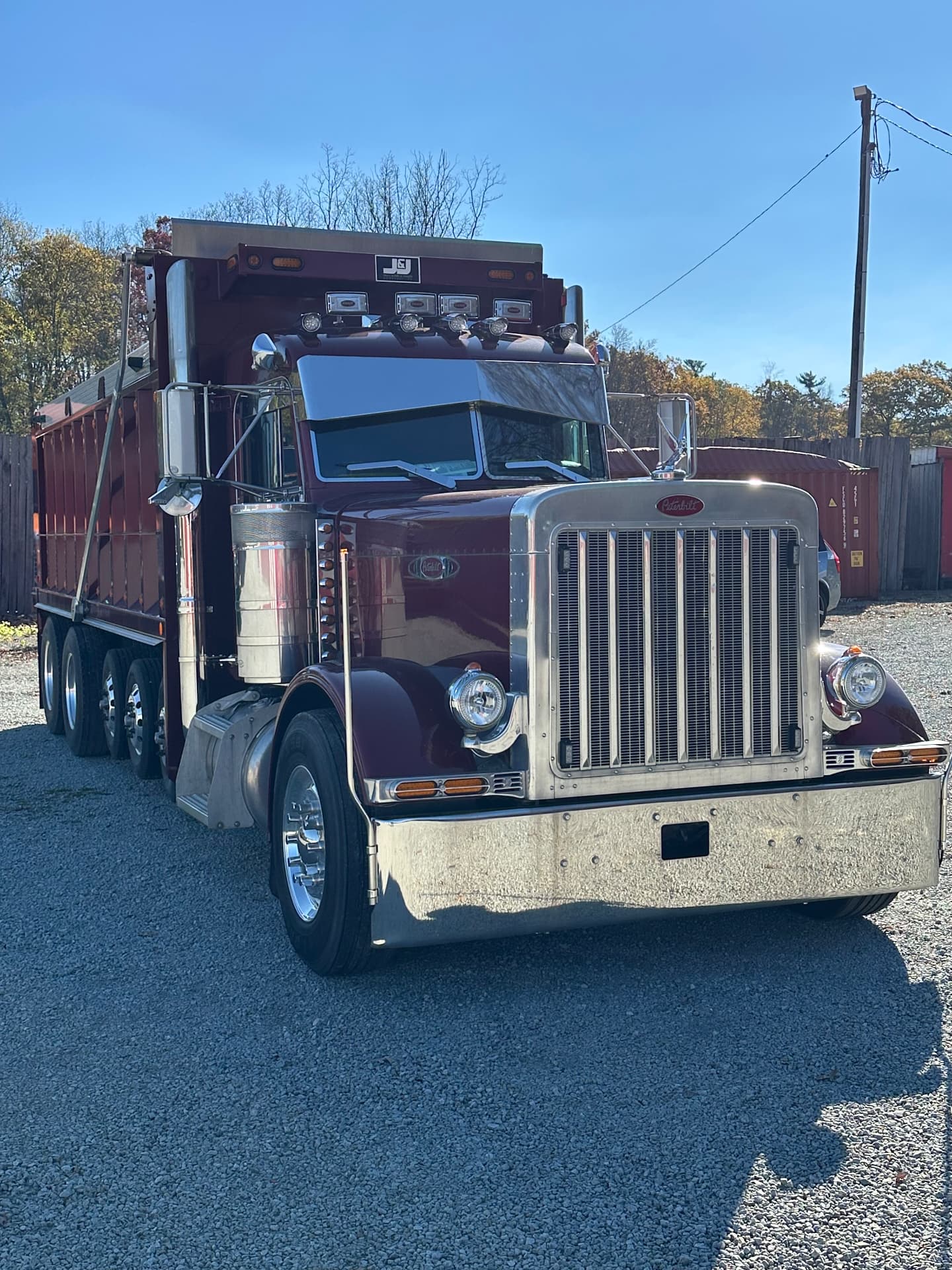 Maroon Peterbilt dump truck front view